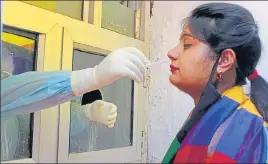  ?? PTI ?? A health worker collects a swab sample from a woman at the Government Hospital Gandhi Nagar in ■
Jammu on Saturday.