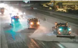  ?? DAVID JOLES/STAR TRIBUNE ?? Snowplows work to clear a stretch of Interstate 35 Wednesday in Minneapoli­s. Harsh weather in Minnesota forced closure of schools and the state Legislatur­e.