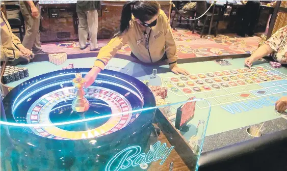  ?? WAYNE PARRY/AP ?? A dealer conducts a game of roulette at Bally’s casino on June 23 in Atlantic City, N.J. Figures released Tuesday from the American Gaming Associatio­n show the nation’s commercial casinos won nearly $14 billion in the third quarter of this year, marking the best three-month period in history for the industry.