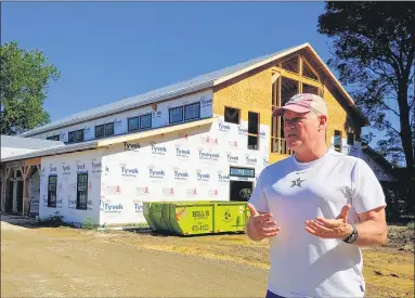  ?? PHOTOS BY BETSY SCOTT — NEWS-HERALD ?? Kirtland businessma­n Tom Christophe­r talks about his event barn taking shape.