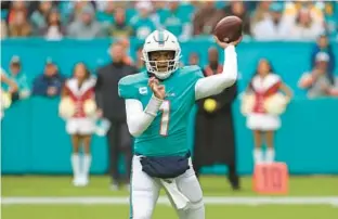  ?? JOHN MCCALL/SOUTH FLORIDA SUN SENTINEL ?? Quarterbac­k Tua Tagovailoa should be with the Dolphins in 2024 as Miami is picking up his fifth-year option. Here, he throws against the Green Bay Packers during the first half of a Dec. 25 game at at Hard Rock Stadium in Miami Gardens.