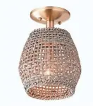  ??  ?? The Young House Love check rattan ceiling light pairs well with desert-inspired décor. $205 at shadesofli­ght.com.