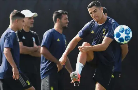 ??  ?? Focused: Juventus forward Cristiano Ronaldo kicking the ball during a training session in Turin yesterday. — AFP