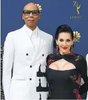  ??  ?? Rupaul’s suit by Calvin Klein makes “a political statement” with black Statues of Liberty. The host of Rupaul’s Drag Race is seen with Michelle Visage.