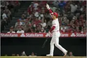  ?? ASHLEY LANDIS — THE ASSOCIATED PRESS ?? Los Angeles Angels’ Shohei Ohtani (17) is walked by Kansas City Royals starting pitcher Daniel Lynch (52) during a game in Anaheim, Calif., Wednesday.