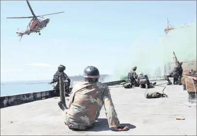  ?? PICTURE: LEON LESTRADE ?? RESCUE: The roof of The Gooderson Beach Hotel was the scene of a daring mock military rescue yesterday, as armed forces staged a fulldress rehearsal for a live military combat capability demonstrat­ion on Durban’s beachfront, starting at 10am.