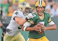  ?? USA TODAY NETWORK-WISCONSIN ?? Packers quarterbac­k Brett Hundley gets sacked against the New Orleans Saints during a preseason game on Sept. 3, 2015, at Lambeau Field.