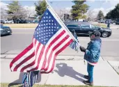  ?? DAVID ZALUBOWSKI/AP ?? Joe Duran, of Thornton, Colo., salutes Tuesday as a hearse carries the casket of Officer Eric Talley.