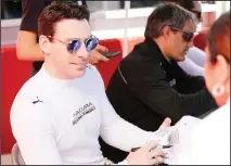  ??  ?? In this Jan 25, 2020 file photo, Acura Team Penske driver Simon Pagenaud, (left), signs autographs before the Rolex 24-hour auto race at
Daytona Internatio­nal Speedway in Daytona Beach, Florida.