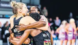  ?? COURTESY OF SUPERNETBA­LL.COM ?? Sunshine Girl and Collingwoo­d Magpies goal shooter, Shimona Nelson (right), is hugged by teammates, another Sunshine Girl Jodi-Ann Ward (centre), and Jacqui Newton after their team’s 71-67 Suncorp Super Netball League win over the Queensland Firebirds inside Tasmania’s MyState Bank Arena on Sunday.