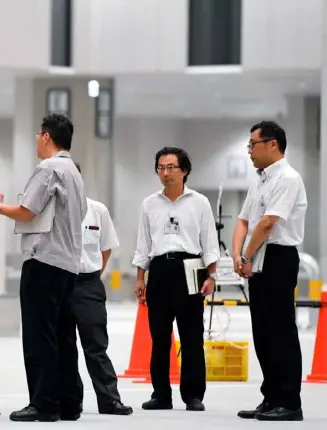  ??  ?? Clockwise from top: Tokyo Governor Yuriko Koike inspects the new Toyosu fish market site in August; the market under constructi­on; Koike addresses foreign journalist­s; tuna being transporte­d in the Tsukiji fish market.