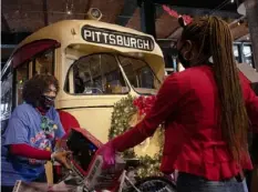  ?? Pittsburgh Post-Gazette ?? Lynn Batch, mother of former Steelers quarterbac­k Charlie Batch, helps with the Batch of Toys Annual Holiday toy collection “Stuff the Trolley” event at the Heinz History Center in the Strip in December 2020. Toys can be dropped off at the History Center through Dec. 21.
