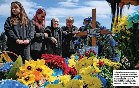  ?? Leon Neal ?? Family members mourn at the graveside of soldier Yuri Varyanytsi­a during the burial of soldiers in the Field of Mars at Lychakiv cemetery in Lviv, Ukraine