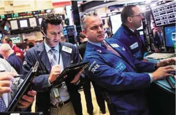  ?? AFP ?? Braving the storm Traders at the New York Stock Exchange yesterday. Nervousnes­s was already building ahead of an expected US interest rate hike this week.