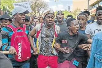  ?? Picture: AFP PHOTO / MUJAHID SAFODIEN ?? STEADFAST: Students from Wits University shout slogans and hold placards during a protest march for free higher education on Friday.