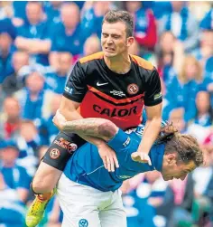  ??  ?? Stevie May is challenged by Dundee United’s Gavin Gunning during the Scottish Cup final.