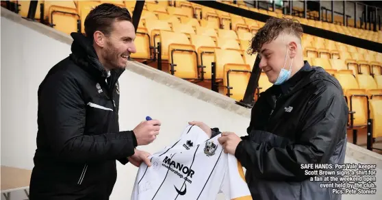  ??  ?? SAFE HANDS: Port Vale keeper Scott Brown signs a shirt for a fan at the weekend open event held by the club. Pics: Pete Stonier