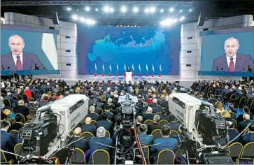  ?? Alexander Nemenov AFP/Getty Images ?? VLADIMIR PUTIN delivers his state of the nation address in Moscow. Speaking of U.S. missiles deployed in NATO countries, the Russian president said, “We don’t want confrontat­ion .... But Russia will always respond.”