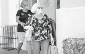  ?? AMY BETH BENNETT/SOUTH FLORIDA SUN SENTINEL ?? Shoppers and employees wear masks at Trader Joe’s grocery store in Boca Raton on June 25.