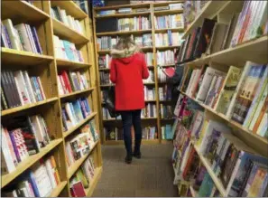  ?? PHOTOS BY JONATHAN ELDERFIELD — THE ASSOCIATED PRESS ?? In this photo, shoppers browse among the narrow rows of books at The Book Loft of German Village in Columbus, Ohio.