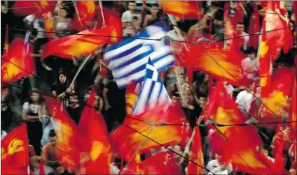  ?? KOSTAS TSIRONIS/ AP ?? Supporters of the Greek Communist party wave flags during the main pre- election campaign in central Athens on Friday.