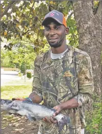 ?? Submitted photo ?? REELING IN CASH: Joe Thomas, of Hot Springs, holds the second prize fish caught in the 2018 Hot Springs Fishing Challenge which he reeled in on Lake Hamilton over the weekend. The channel catfish is worth $1,000.
