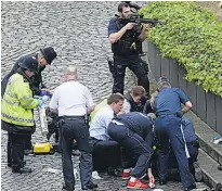  ?? Picture / AP ?? Police and emergency workers respond to the terrorist attack in Westminste­r.