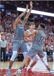  ?? ASSOCIATED PRESS ?? UW’s Ethan Happ (center) has been double-teamed the last two games, including in Sunday’s loss to Northweste­rn.
