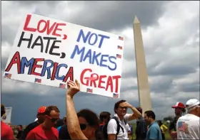  ?? AP Photo/Patrick Semansky ?? Rally: Kathleen Otal, of Arlington, Va., holds up a sign before Independen­ce Day celebratio­ns, Thursday, July 4, 2019, on the National Mall in Washington.