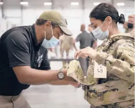  ?? JASON AMADI/U.S. ARMY ?? Sgt. Katiushka Rivera, a soldier assigned to the 82nd Airborne, gets fitted for a modular scalable vest during a fielding event last month at Fort Bragg, North Carolina.