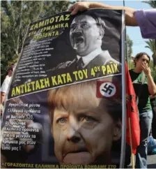  ?? AP PHOTO ?? A protester holds a poster comparing Nazi leader Adolf Hitler and German Chancellor Angela Merkel during a nationwide general strike in Athens on Wednesday. Writing on the poster reads: “Boycott German products. Resist the Fourth Reich.”