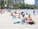  ?? CALEB JONES/AP ?? Tourists sit Monday on Waikiki Beach in Honolulu. With cases climbing for eight consecutiv­e weeks, Hawaii has the secondhigh­est infection rate among the 50 states.