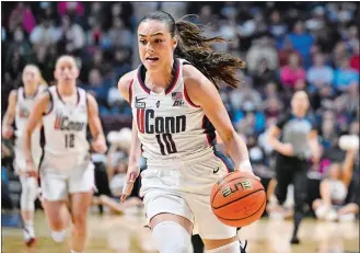  ?? JESSICA HILL/AP PHOTO ?? UConn guard Nika Muhl dribbles during the first half of Monday’s Big East Conference tournament final against Georgetown at Mohegan Sun Arena.