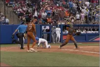  ?? ?? Texas defeated UCLA in the Longhorns’ return to the College World Series after a long absence from the stage. Ferndale native Hailey Dolcini (27) dealt to the Bruins in the CWS opener.