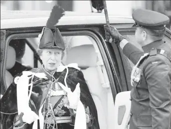  ?? ?? Warrant Officer II Glenrory Low holds an umbrella over Princess Anne on her arrival at Westminste­r Abbey for the Coronation of King Charles II