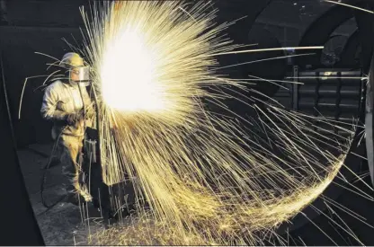  ?? Getty Images ?? This file photo taken last January shows a worker cutting steel in Qingdao in China’s eastern Shandong province. In the trade war with China, tariffs on imports have in some cases erased the benefits that United States companies stood to reap from Donald Trump’s tax cut.