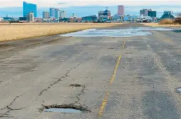  ?? WAYNE PARRY/AP ?? A runway at the former Bader Field airport with casinos in the background Feb. 18 in Atlantic City, N.J. A proposal for the former airport site includes housing and canals.