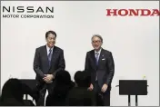  ?? KYODO NEWS VIA AP ?? Nissan Chief Executive Makoto Uchida, left, and Honda President Toshihiro Mibe attend a joint news conference in Tokyo on Friday.