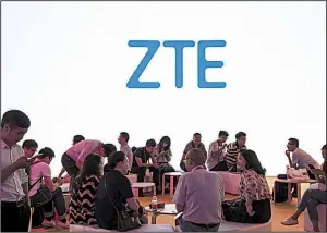  ?? Bloomberg News ?? A ZTE Corp. logo is displayed at a technical industry trade show in Shanghai in June. The removal of the U.S. ban on ZTE was a key demand of China as tension escalates between the countries.