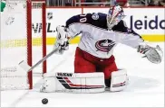  ?? ROB CARR / GETTY IMAGES ?? Goalie Joonas Korpisalo made 32 saves in a 2-1 overtime win over the Capitals on Saturday night in D.C. It was the Blue Jackets’ second victory by that score at Capital One Arena and second OT win in a row.