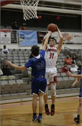  ?? PAUL DICICCO — FOR THE NEWS-HERALD ?? Perry’s Javin Richards shoots over Madison’s Sam Cost on Feb. 22.