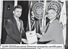  ??  ?? SLIM Ceo/executive Director presents certificat­es