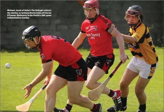  ??  ?? Michael Jacob of Oulart-The Ballagh collects the sliothar as Anthony Roche holds off Ciarán O’Connor (Rathnure) in the Pettitt’s SHC game in Bellefield on Sunday.