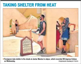  ??  ?? Foreigners take shelter in the shade at Jantar Mantar in Jaipur, which recorded 36 degrees Celsius on Wednesday. PRABHAKAR SHARMA/HT PHOTO