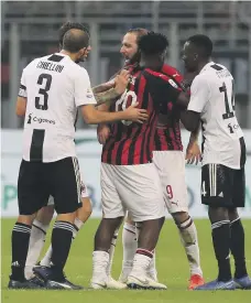  ?? Getty ?? Gonzalo Higuain is ushered past the touchline by his AC Milan teammates after being shown the red card against Juventus