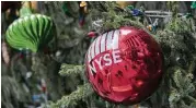  ?? Mary Altaffer / Associated Press ?? The New York Stock Exchange is reflected on a Christmas ornament outside the exchange.