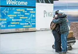  ?? ALEXANDER F. YUAN/AP ?? Abdullah Alghazali, right, hugs son Ali Abdullah Alghazali after the Yemeni teen arrived Feb. 5 at JFK airport in New York. Yemen remains one of six nations on the travel ban list.