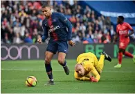  ?? AFP ?? Paris Saint-Germain’s Kylian Mbappe controls the ball past Nîmes’ goalkeeper Paul Bernardoni during the French L1 match on Saturday. —
