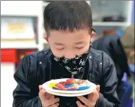  ?? PROVIDED TO CHINA DAILY ?? A boy shows off a piece of art he has made.