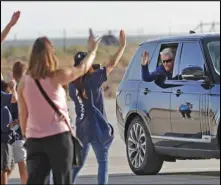  ?? ANDRES LEIGHTON/AP ?? Virgin Galactic founder Richard Branson waves to school children while heading to board the rocket plane that will fly him to space from Spaceport America near Truth or Consequenc­es, New Mexico, Sunday.